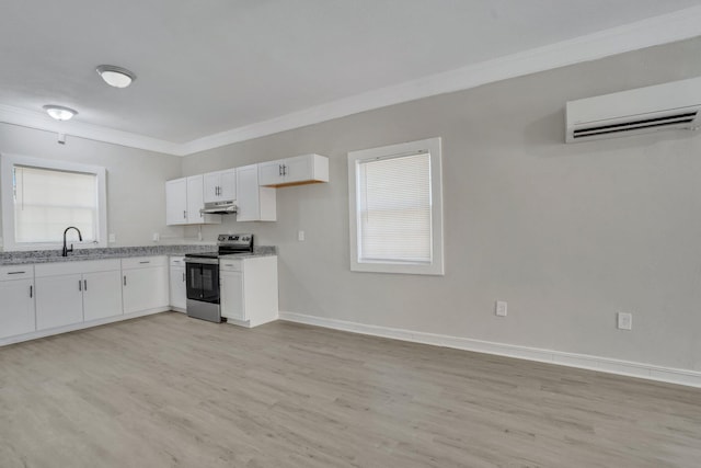 1910 Kerry St, North Charleston, SC 29406 - kitchen with stainless steel electric range, crown molding, under cabinet range hood, an AC wall unit, and white cabinetry