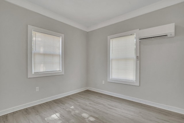 1910 Kerry St, North Charleston, SC 29406 - empty room featuring a wall mounted air conditioner, light wood finished floors, and baseboards