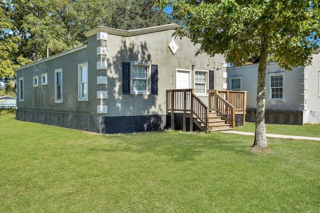 1910 Kerry St, North Charleston, SC 29406 - view of front facade with a front lawn and stucco siding