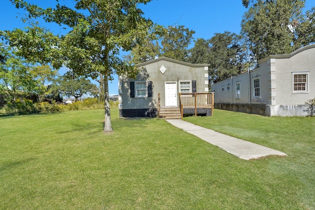 view of front of house with a deck and a front lawn