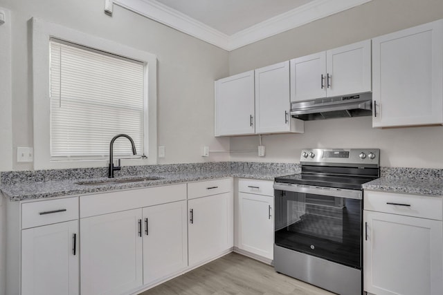 kitchen featuring plenty of natural light, stainless steel range with electric stovetop, white cabinetry, and sink