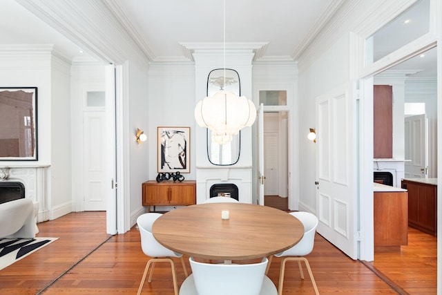 155 Wentworth St Unit A, Charleston, SC 29401 - dining room featuring baseboards, ornamental molding, light wood finished floors, and a fireplace