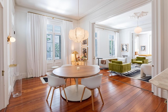 155 Wentworth St Unit A, Charleston, SC 29401 - dining space with a healthy amount of sunlight, ornamental molding, and hardwood / wood-style flooring