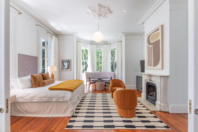 155 Wentworth St Unit A, Charleston, SC 29401 - bedroom with ornamental molding, a fireplace, wood finished floors, and multiple windows