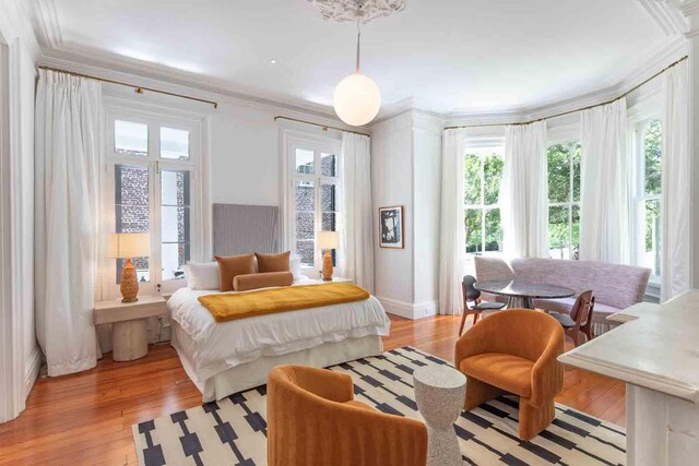 155 Wentworth St Unit A, Charleston, SC 29401 - bedroom with crown molding, baseboards, and light wood-style floors