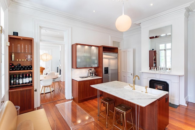 155 Wentworth St Unit A, Charleston, SC 29401 - kitchen featuring stainless steel built in fridge, crown molding, a breakfast bar area, and light wood-type flooring