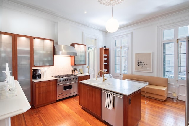 155 Wentworth St Unit A, Charleston, SC 29401 - kitchen with light wood-type flooring, a sink, appliances with stainless steel finishes, and a wealth of natural light