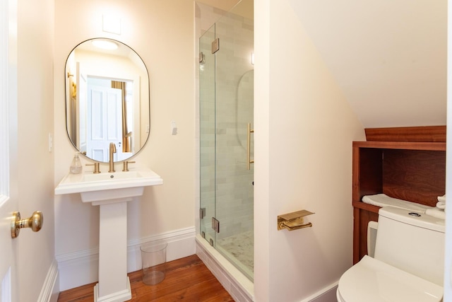 155 Wentworth St Unit A, Charleston, SC 29401 - bathroom with baseboards, wood finished floors, toilet, and a shower stall