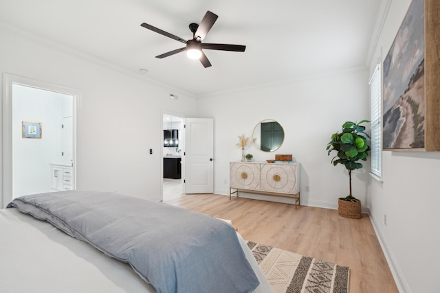 bedroom featuring crown molding, ceiling fan, ensuite bathroom, and light wood-type flooring