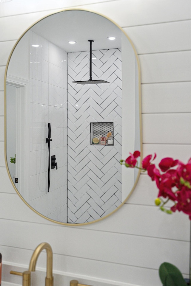 interior details with a tile shower