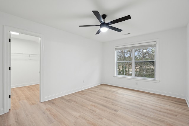 spare room featuring light hardwood / wood-style floors and ceiling fan