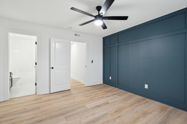 unfurnished bedroom with connected bathroom, a closet, ceiling fan, and light wood-type flooring