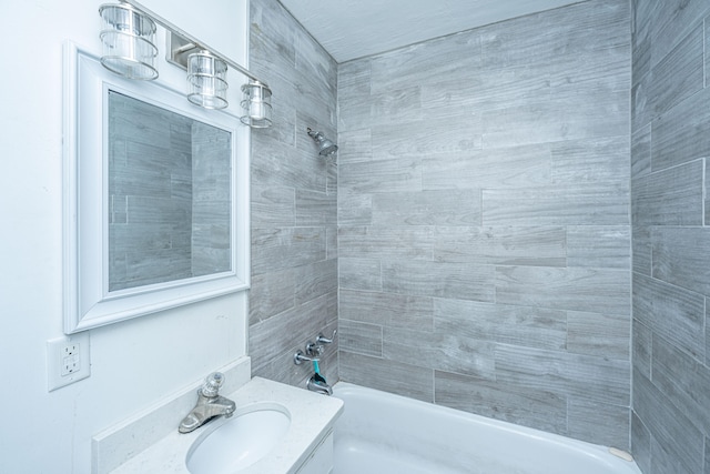 bathroom with vanity and tiled shower / bath combo