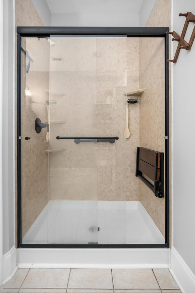 bathroom with walk in shower and tile patterned flooring