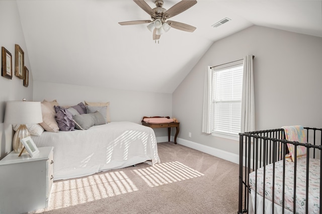 bedroom with ceiling fan, light colored carpet, and lofted ceiling