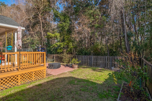 view of yard featuring a fire pit, a patio area, and a wooden deck