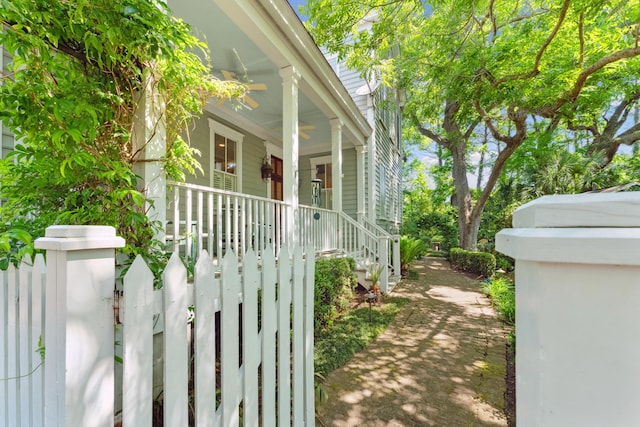 view of side of property with a porch and ceiling fan