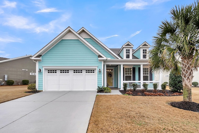 craftsman inspired home with a porch, a garage, and a front yard