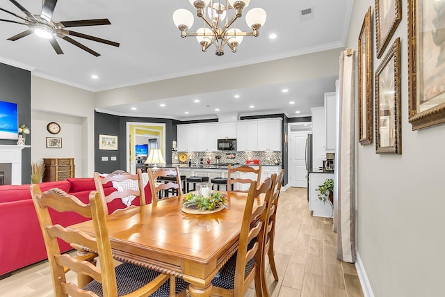 3115 Cross Vine Ln, Summerville, SC 29483 - dining space with light wood-style floors, a fireplace, visible vents, and ornamental molding
