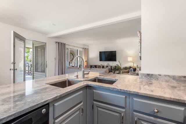 kitchen with gray cabinets, sink, black dishwasher, and light stone counters