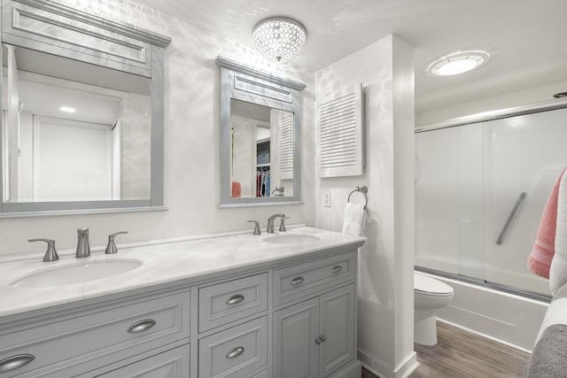 1647 Live Oak Park, Seabrook Island, SC 29455 - bathroom with double vanity, combined bath / shower with glass door, wood finished floors, and toilet