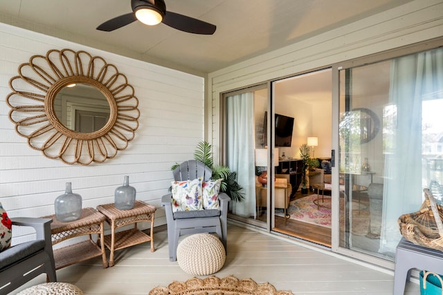 sunroom featuring ceiling fan