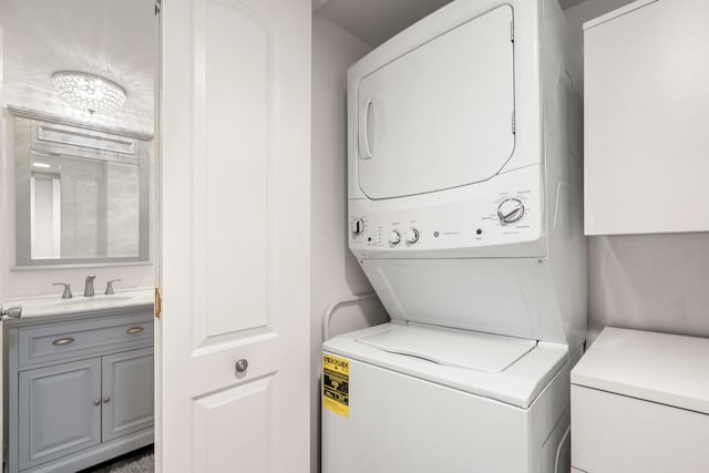 clothes washing area with sink and stacked washer / drying machine