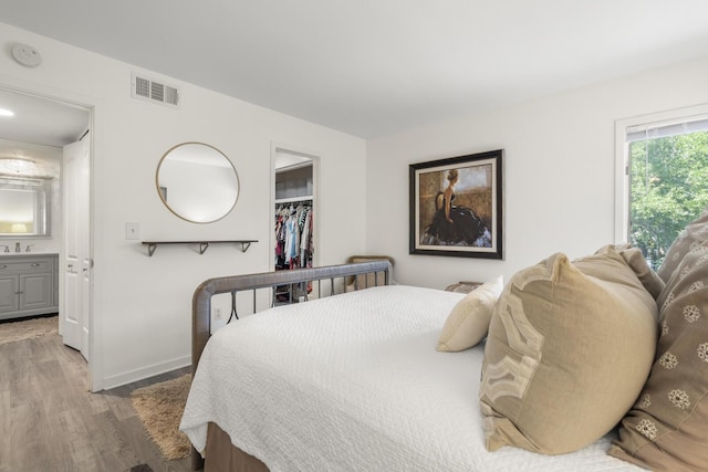 1647 Live Oak Park, Seabrook Island, SC 29455 - bedroom with light wood-style floors, a walk in closet, a closet, baseboards, and connected bathroom
