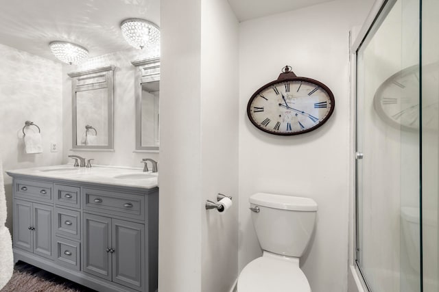 bathroom with double sink vanity and toilet