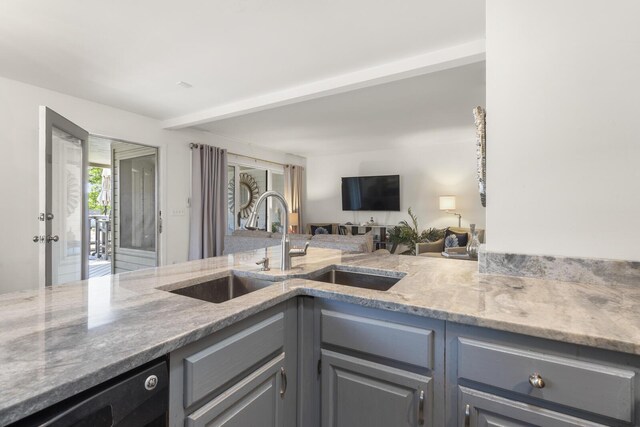 1647 Live Oak Park, Seabrook Island, SC 29455 - kitchen featuring gray cabinetry, a sink, light stone countertops, open floor plan, and beam ceiling