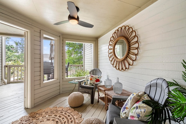 sunroom featuring ceiling fan