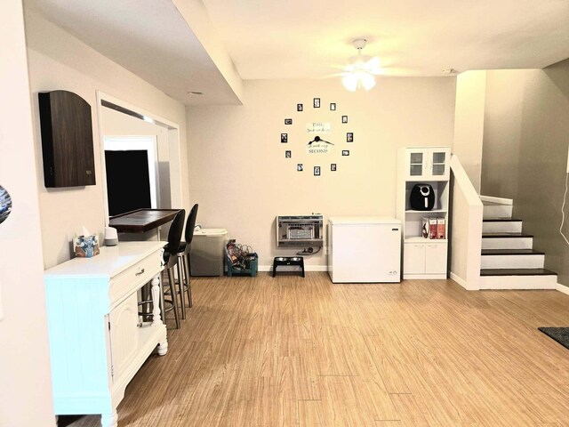 9489 Sidneys Rd, Round O, SC 29474 - kitchen with fridge, light wood-type flooring, a ceiling fan, heating unit, and baseboards