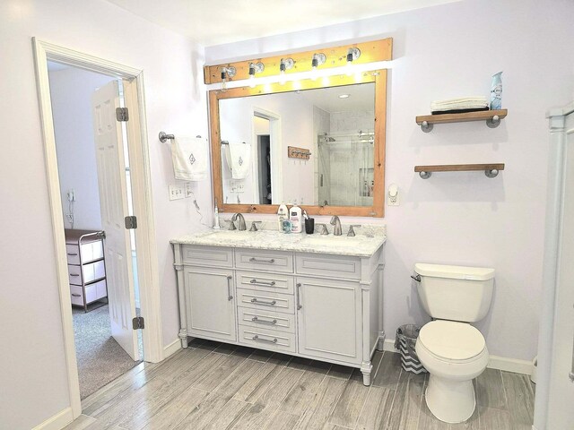 9489 Sidneys Rd, Round O, SC 29474 - full bathroom featuring wood finish floors, a shower stall, double vanity, baseboards, and toilet