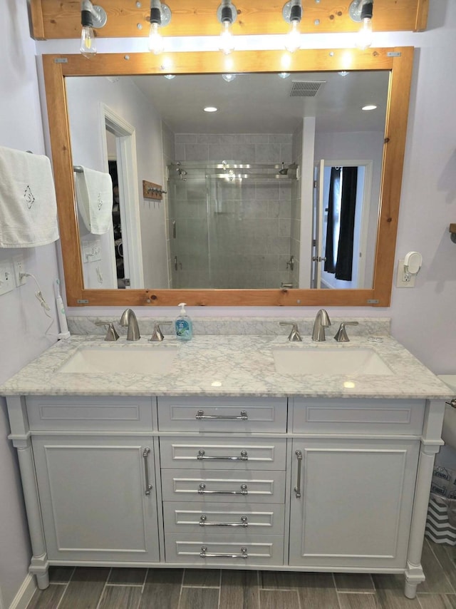 9489 Sidneys Rd, Round O, SC 29474 - bathroom featuring tiled shower, double vanity, and wood tiled floors