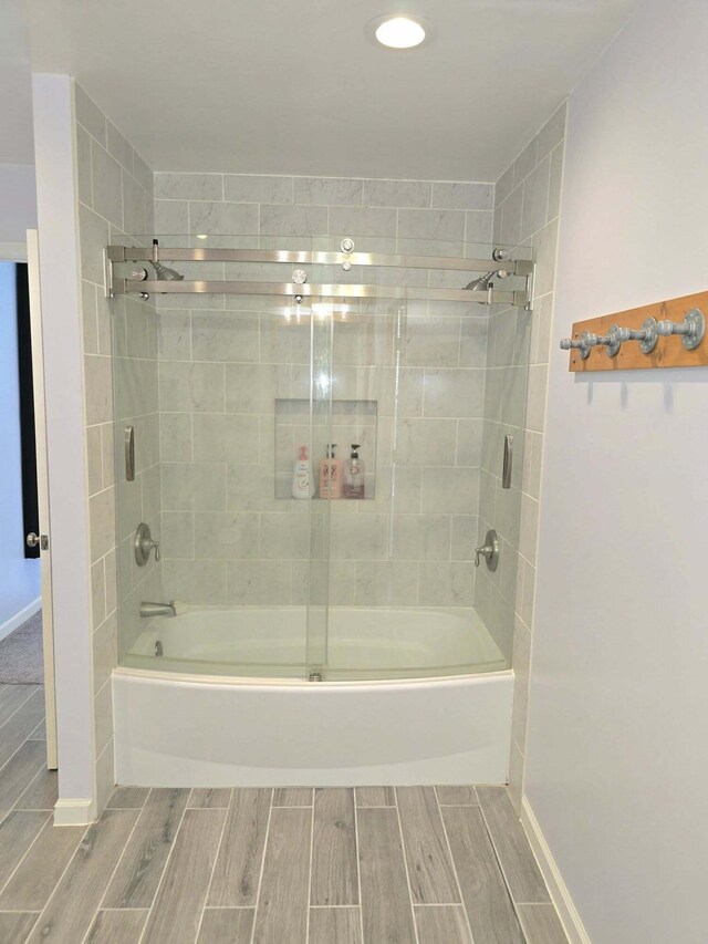 9489 Sidneys Rd, Round O, SC 29474 - full bathroom featuring wood tiled floors, enclosed tub / shower combo, and baseboards