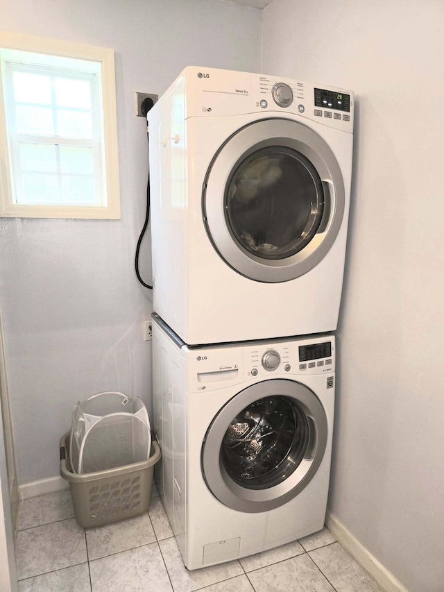 9489 Sidneys Rd, Round O, SC 29474 - laundry room featuring stacked washer / dryer, baseboards, and light tile patterned floors
