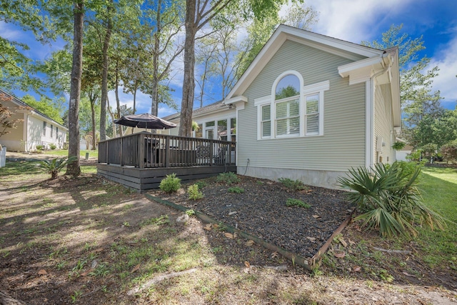 rear view of house featuring a deck