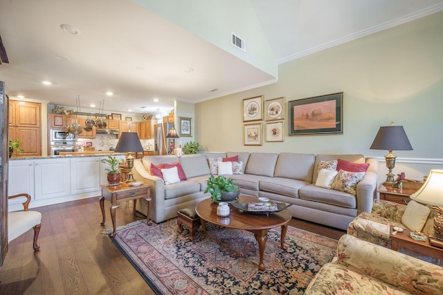living area featuring dark wood-style flooring, ornamental molding, visible vents, and recessed lighting