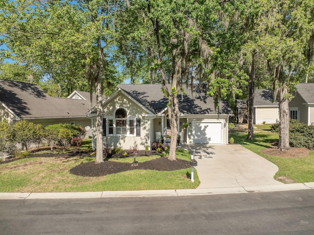 view of front of property with an attached garage, concrete driveway, and a front lawn