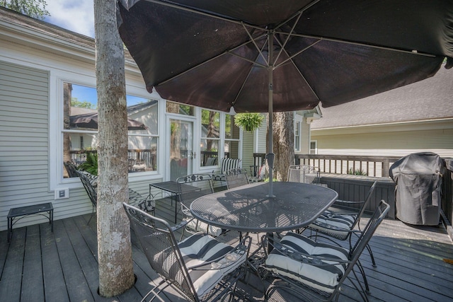 deck with grilling area and outdoor dining space