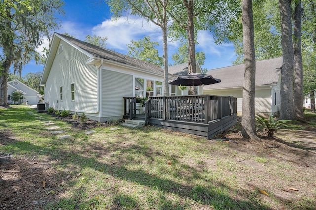 back of house with a yard, central AC, and a wooden deck