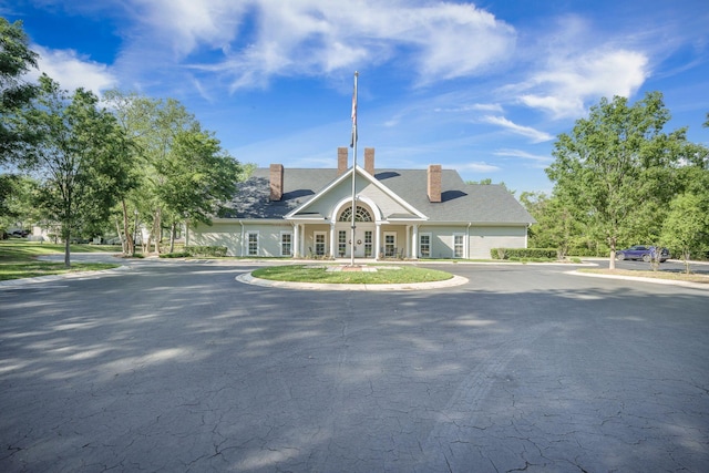 view of property with curved driveway