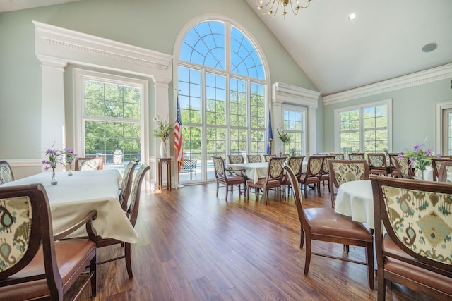 dining area featuring a chandelier, wood finished floors, high vaulted ceiling, and recessed lighting