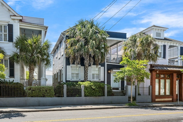 view of front of home featuring a fenced front yard and a balcony