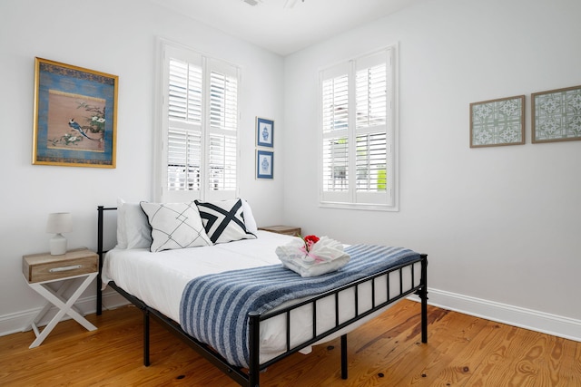 bedroom featuring baseboards and wood finished floors