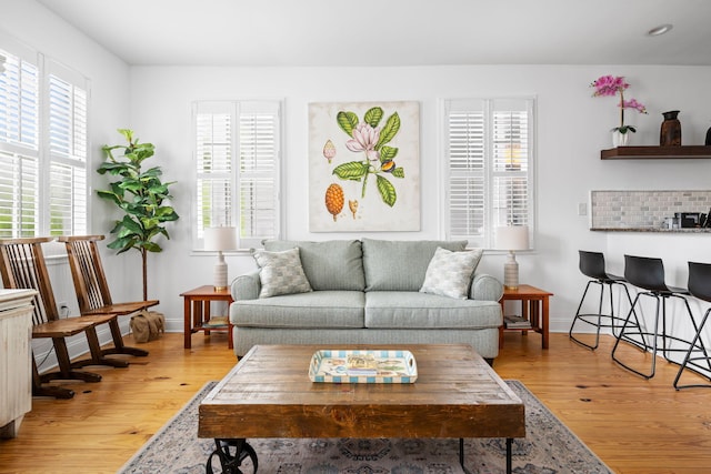 living area with light wood finished floors and baseboards