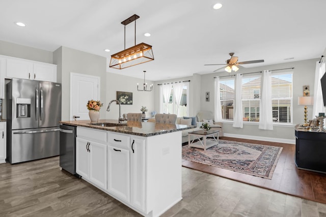 101 Patterson Ave, Goose Creek, SC 29445 - kitchen featuring appliances with stainless steel finishes, dark stone counters, open floor plan, healthy amount of natural light, and recessed lighting