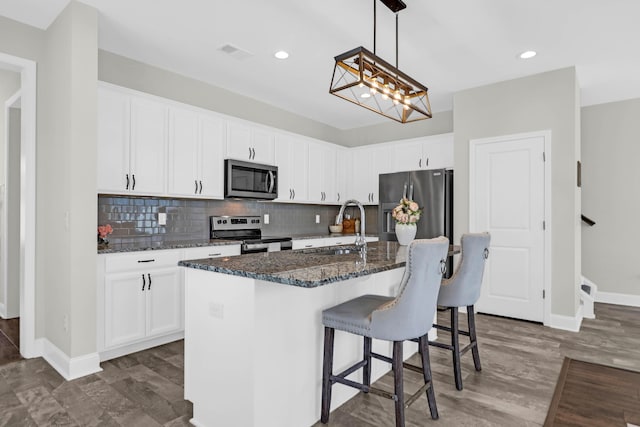 101 Patterson Ave, Goose Creek, SC 29445 - kitchen featuring appliances with stainless steel finishes, dark stone counters, white cabinetry, and recessed lighting
