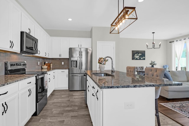 101 Patterson Ave, Goose Creek, SC 29445 - kitchen with stainless steel appliances, a chandelier, a breakfast bar, dark stone countertops, and recessed lighting