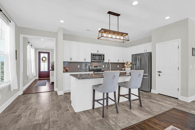 101 Patterson Ave, Goose Creek, SC 29445 - kitchen with stainless steel appliances, a kitchen island with sink, tasteful backsplash, white cabinetry, and recessed lighting